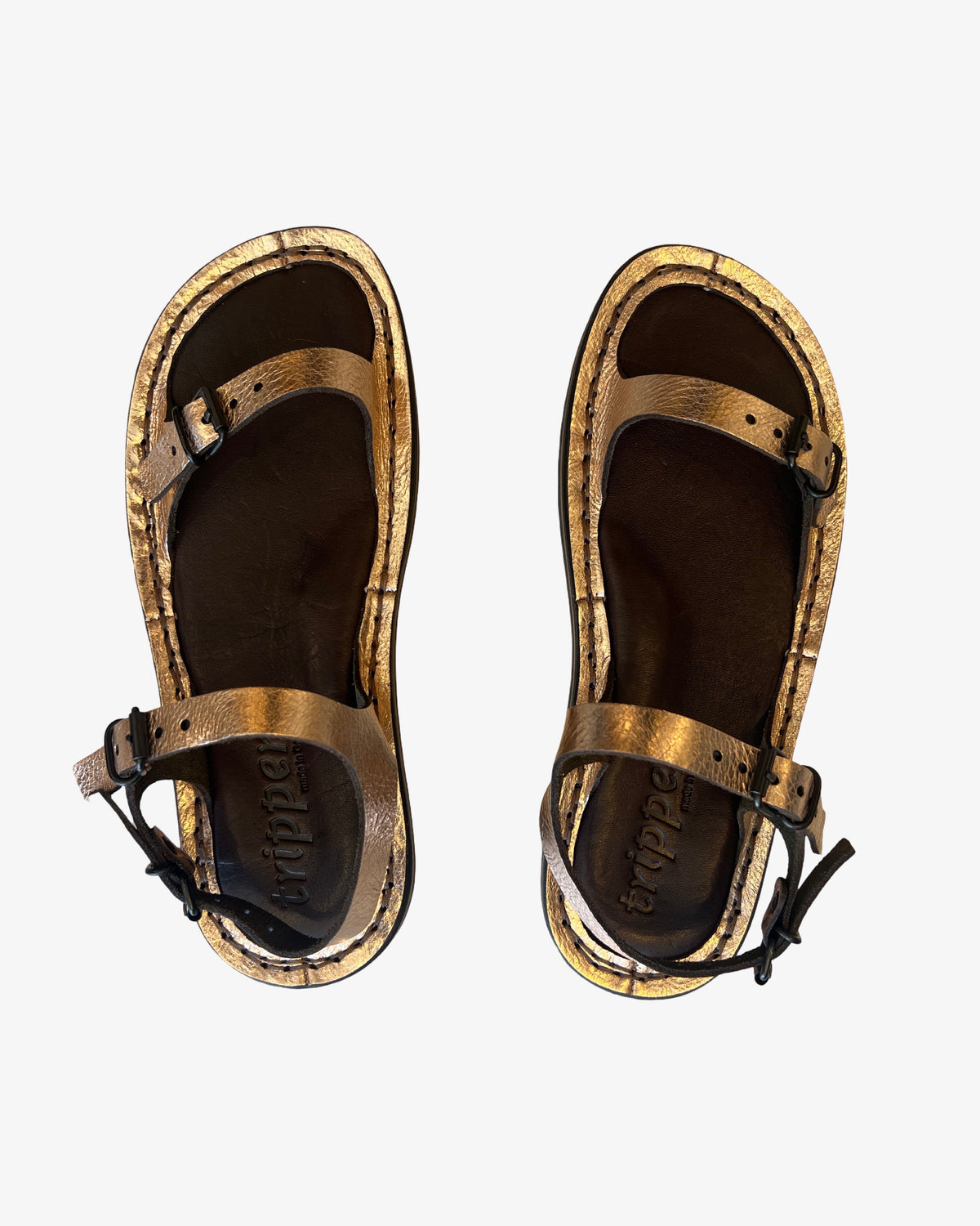 Trippen Slender copper metallic leather sandal with adjustable toe, instep, and heel buckle straps, two-tone footbed, and rubber sole, handmade in Germany. Overhead product shot