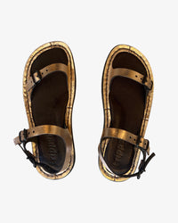 Trippen Slender copper metallic leather sandal with adjustable toe, instep, and heel buckle straps, two-tone footbed, and rubber sole, handmade in Germany. Overhead product shot